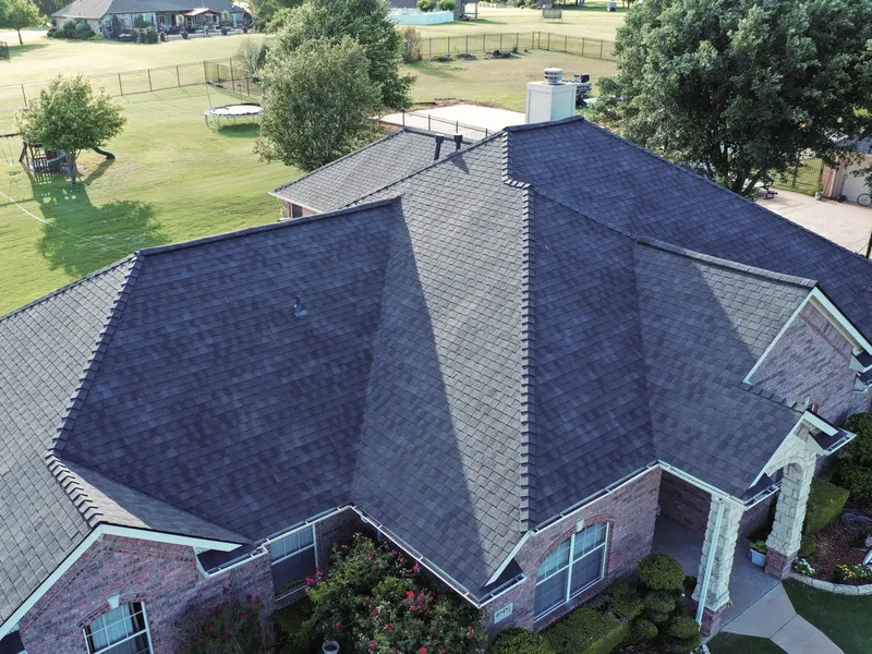 Completed shingle roof replacement on a single-storey brick home, seen from above